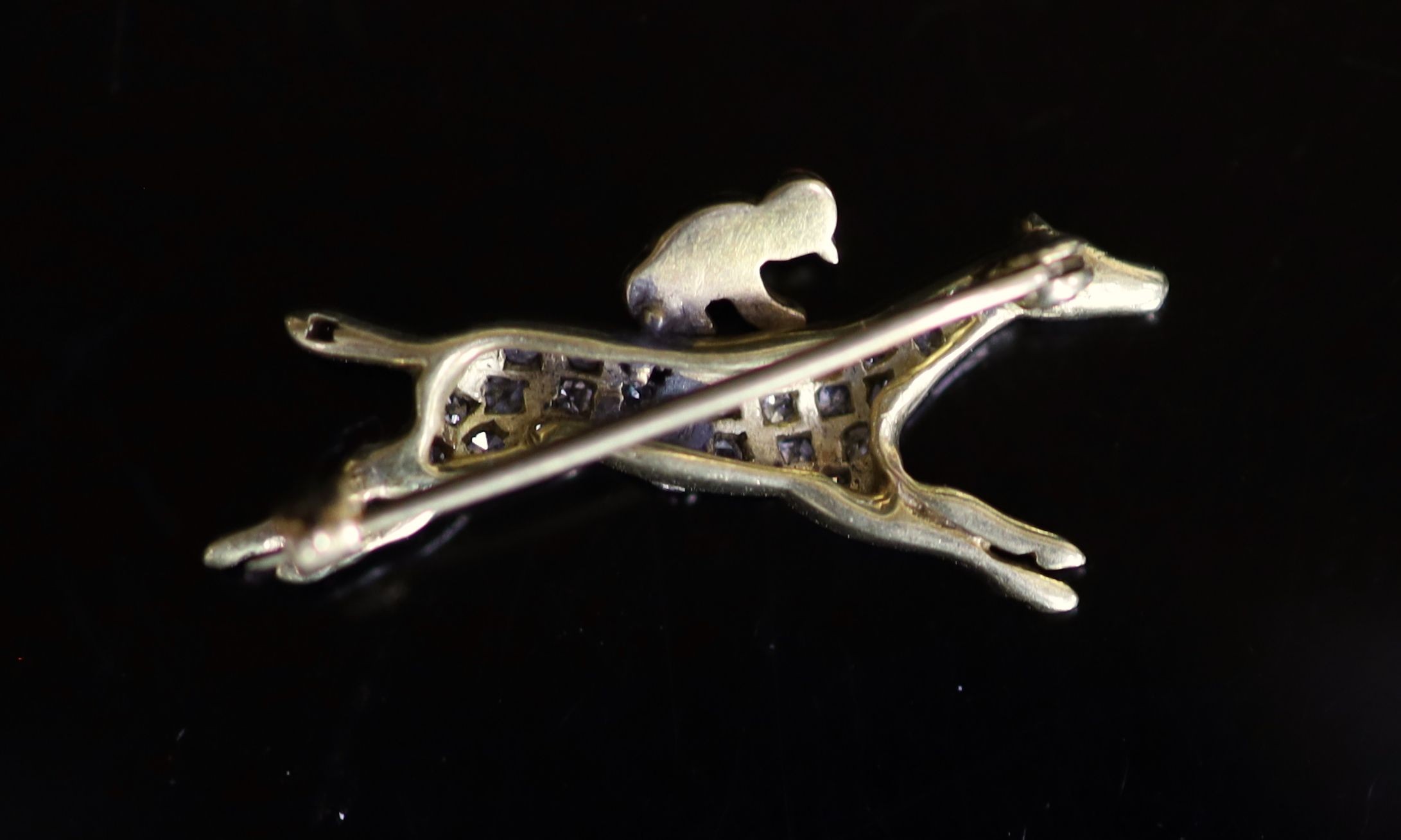 An early 20th century gold, diamond chip and enamel set 'horse and jockey' brooch